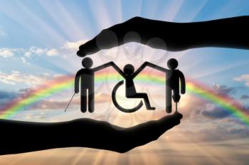 Disabled Society to hold hands in handbreadth against backdrop of rainbow. Concept help disabled persons