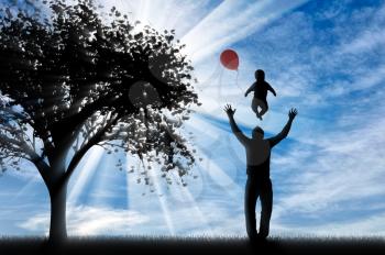 Happy Dad playing with child and balloon near tree. Concept of family and happiness