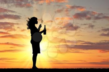 Concept of pregnancy and bad habits. Silhouette of a pregnant woman smokes a cigarette with an alcoholic drink at sunset