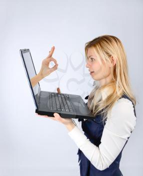  Concept of consent. Ok hand gesture of a laptop and a businesswoman