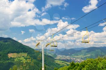 Chair lift on a background of mountain valley. Summer season