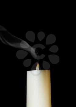 Ignition white candle. Isolated on a black background