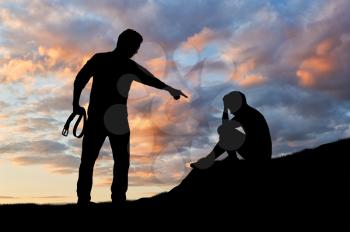 Child abuse and bullying in the family. Silhouette of a crying frightened boy and aggressive father with a belt in his hand