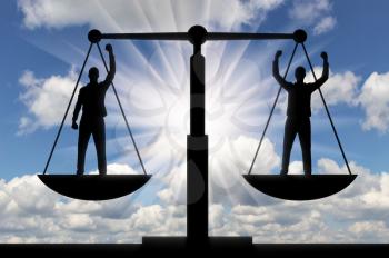 Silhouette of two men are equal to standing on the scales of justice. Business concept of mutual benefit and success of business partners
