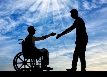 The employer intends to shake hands with a man in a wheelchair. The concept of providing work to people with disabilities