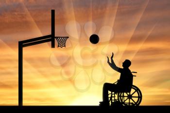 Disabled person playing basketball in a wheelchair outdoors. The concept of sports lifestyle people with disabilities