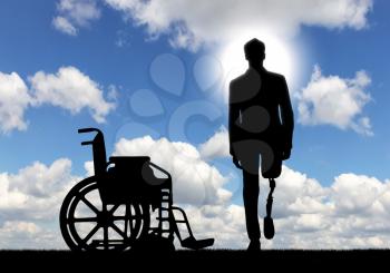 Disability and rehabilitation. Walking is a disabled man with a prosthetic leg and a wheelchair outdoors