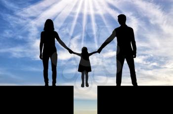 Divorce in the family. Silhouette mom and dad hold the hands of his child who is over the precipice. The concept of divorce and division of children