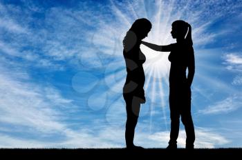 A silhouette of a woman morally supports another woman. The concept of support and help to people