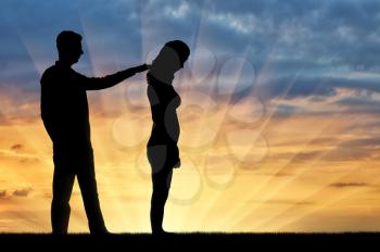 A silhouette of a man morally supports a sad woman. The concept of support and help to people