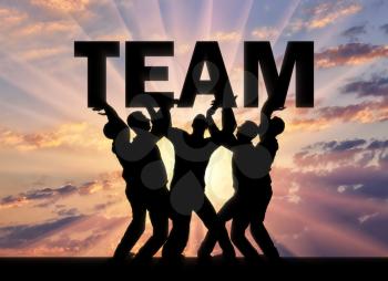 Silhouette of a group of men who hold the word team above themselves. The concept of a business team and teamwork