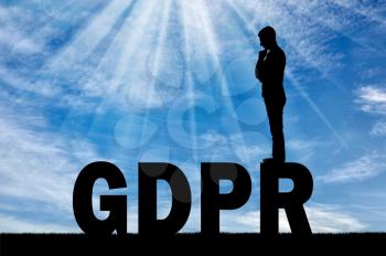 Silhouette pensive man standing on the word GDPR. Conceptual image about the law GDPR