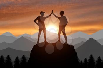 Silhouette of two happy climber conquered the top. A conceptual scene of success working in a team