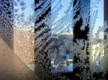 Photos of beautiful frost pattern on a window glass.