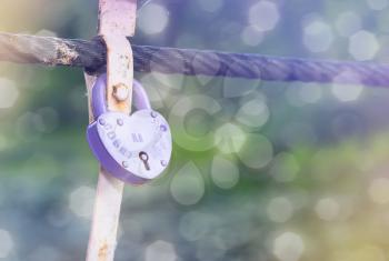 Romantic Photo with purple closed lock and bokeh.