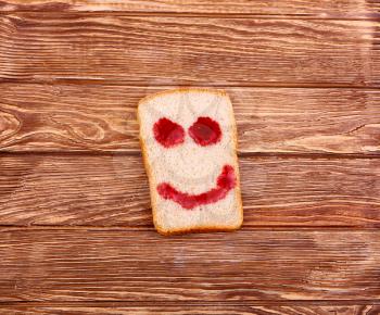 slice of bread with a smile on a wooden