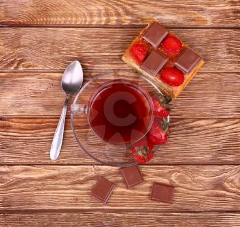 sweet cake with cup of tea on wooden table