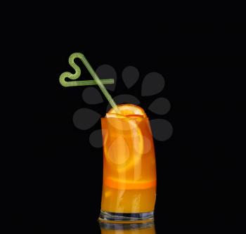 fresh organic orange juice and vodka in a tall glass  on a black background 