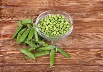 peas on a wooden bowl in a glass