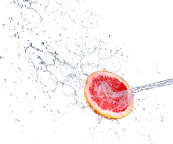 Studio shot of fresh grapefruit with water splash, isolated on white background