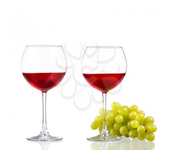 Glass of red wine and white grapes isolated on white background