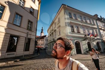Prague, Czechia - 10.08.2019. young man is surprised and enjoys the beautiful old city, tourist