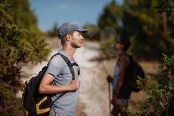 Two hikers men walk on trek in mountain. Trekking in mountains. Hills and mounts in sport tourism. enjoying adventure. Hiker in background.
