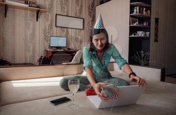 woman celebrating birthday online in quarantine time through video call virtual party. Coronavirus outbreak 2020.