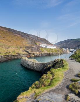 Harbour wall leading up to old houses and cottages in Boscastle, Cornwall, England, UK