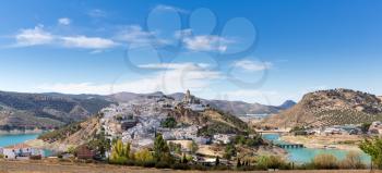 White painted hilltop town of Iznajar by lake in Andalucia in Southern Spain