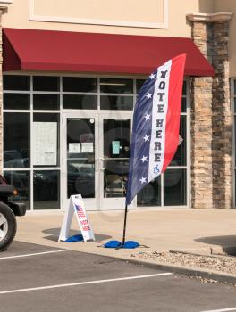 Flag with Vote Here outside an early voting ballot location for the 2016 USA Presidential election