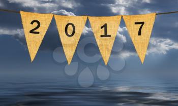 High resolution isolated sack cloth pennants with letters on each to create pennant flag message of New Years Eve 2017 in the  dark stormy sky giving pessimistic view