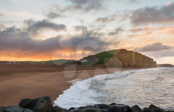 Sunrise at Jurassic Coast cliffs and headland at West Bay in Dorset used as the location for the Broadchurch TV series