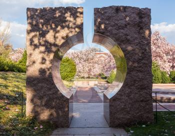 Entrance to Enid A Haupt garden through large granite Moon Gate entranceway in Washington DC