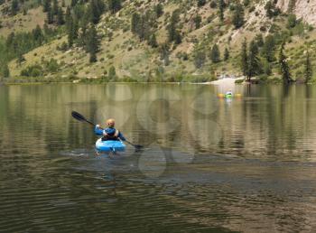 Kayaking on Cottonwood lake in the valley on clear calm day with the lake stretching off to distance