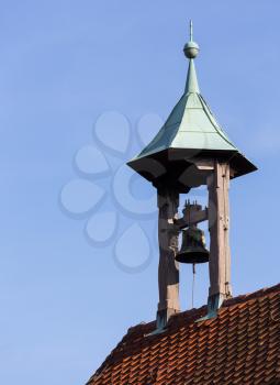 Old church bell tower built from timber posts on roof of small church in Nuremberg, Germany