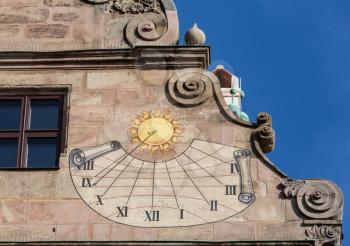Detail of old sundial on the side of Fembohaus Stadtmuseum in Nuremberg, Germany