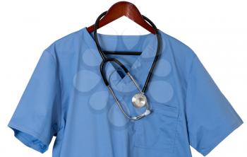 Blue medical scrubs uniform shirt hanging on a hanger with stethoscope with path and isolated against white background