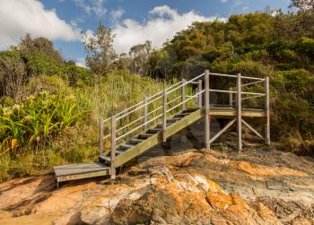 Steps from Diggers Beach to raised walkway along the coast near Coffs Harbour in New South Wales Australia