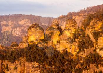 Rising sun illuminates three sisters from Sublime Point overlooking the majestic Blue Mountains near Sydney NSW Australia