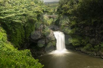 Road to Hana continues over bridge over waterfall into Seven Sacred Pools at state park