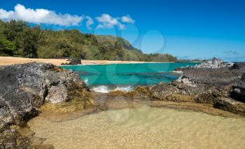 Rock pool frame the turquoise ocean off Lumahai Beach in Kauai in Hawaiian islands