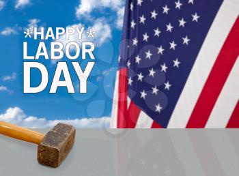 Hammer on metal shelf in front of USA flag for Labor Day background poster