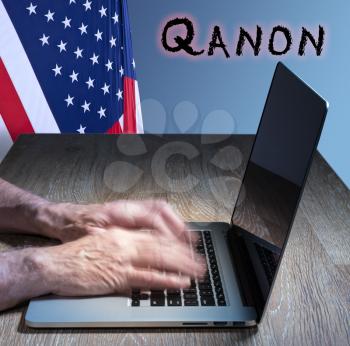 Senior caucasian man types on computer. Concept background illustration for QAnon or Q Anon, a deep state conspiracy theory