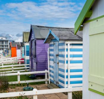 Colorful painted beach hut on its own plot of land along the coast of Devon in Southern England