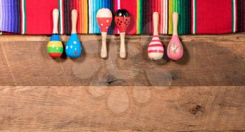 Cinco de Mayo background image on with maracas and serape on wooden rustic boards