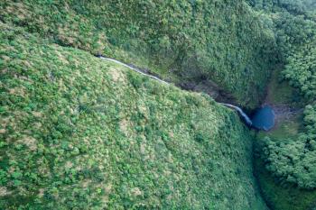 Aerial view of Hanakoa Falls on hawaiian island of Kauai from helicopter flight