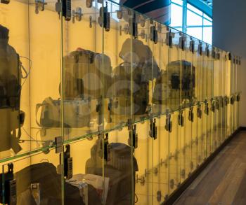 Modern luggage storage solution in airport with glass boxes for carry-on bags