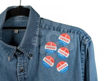 Multiple I Voted Today stickers on the blue denim working shirt collar for midterm elections in the USA with white background