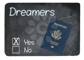 DACA Yes Vote message written in chalk on a chalky natural slate blackboard with Passport for Dreamers